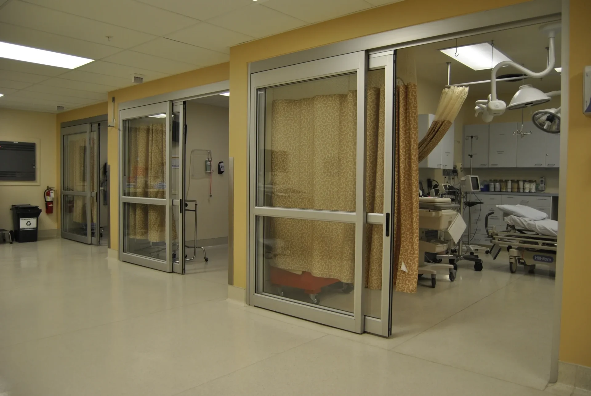 Hospital treatment bay with curtained patient rooms
